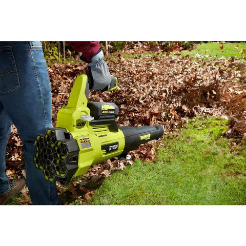 Brushless Cordless Leaf Blower Packs Serious Gas Powered Punch At 125 Mph And 550 Cfm For Smooth Yard Cleanup With Ultra Quiet Whisper Design being used to clear leaves.