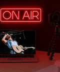 On Air Neon Sign LED Light For Streamers And Gamers Red Lit On Air Sign illuminating desk with laptop and camera setup