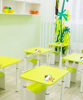 Classroom with Bee Cutouts For Classroom Decorations 50 Pack Name Tags And Desk Nameplates on green desks.