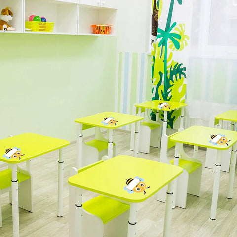 Classroom with Bee Cutouts For Classroom Decorations 50 Pack Name Tags And Desk Nameplates on green desks.