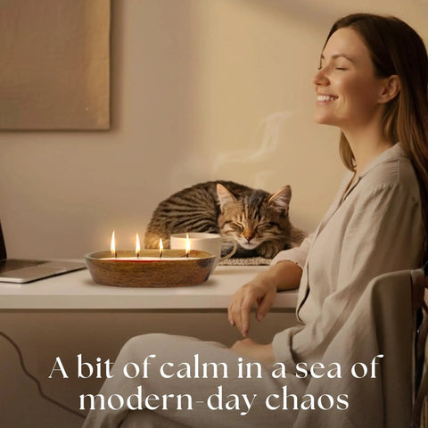 Woman smiling at desk with Sand Candle Kit With 24 Wicks And Ivory Pearled Wax Beads 1 Pound Includes Wood Holder, cat resting