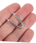 Close-up of a single U-shaped metal fence staple held in hand, part of a 50 Pack U Shaped Fence Staples For Quick Install And Strong Hold Durable Metal Garden Stakes For Fences Landscaping And DIY Projects Multi Function Iron Pegs.