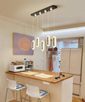 60W Dimmable LED Pendant Chandelier With Remote Control, 5-Light Slick Modern Black Fixture in a kitchen setting.