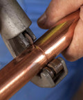 Close-up of 12 Pack Tubing Cutter Blades For Copper Pipes And Hose Tools Replacement Cutter Blades You Can Count On For Models 101 103 104 117 118 150 151 152 153 205 Built From Durable Stainless Steel For Long Lasting Cutting Power in use on copper pipe