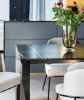 Dining table with Reusable Black Corner Protectors Set 100 Pieces Plastic Box Guards Safety Pads installed on edge