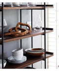 Built Different Heavy Duty Black Iron Bookshelf With Real Wood Shelves Industrial Floor Standing Storage Rack For Living Room Setup Home Office Display Organizer showcasing plates and wooden decor.