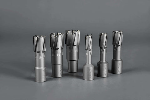 Front view: six carbide annular cutters with Weldon shanks, gray metal, varying diameters.