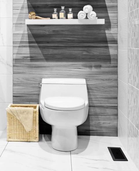 Bathroom with black louvered plastic floor register near toilet, showing durable lattice design and decorative air vent grate.