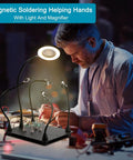 Person using Soldering Helper With Four Magnetic Arms, 3X Magnifier Lamp And LED Light for PCB repair at a workbench.