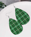 Totally Fire Green Grid Teardrop Faux Leather Dangle Earrings With Silver Plated Hooks on a plate.