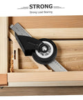 Close-up of a black heavy-duty wheel on a wooden track, part of the Four Pack Heavy Duty Barn Door Rollers Running Like A Dream With Silent Caster Wheels For Cabinet And Wardrobe Sliders Rock Solid Build Zero Drag Glide Super Simple Wall Mount Hardware Kit.
