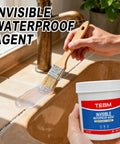 Applying Crystal Clear Waterproof Sealant And Invisible Coating For Roofs Walls And Terraces with a brush on tiled surface.
