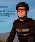 Cyclist wearing Photochromic Cycling Sunglasses For Men With Light Adaptive Lenses Frameless Design For Clear Peripheral Vision Sports Bike Glasses Ready For Any Ride against a scenic background, featuring UV400 protection and HD photochromic technology.