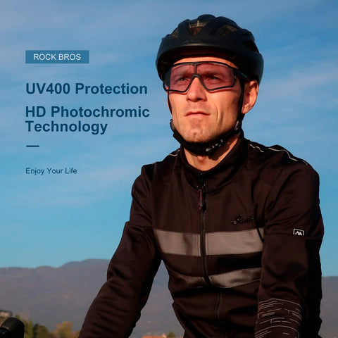 Cyclist wearing Photochromic Cycling Sunglasses For Men With Light Adaptive Lenses Frameless Design For Clear Peripheral Vision Sports Bike Glasses Ready For Any Ride against a scenic background, featuring UV400 protection and HD photochromic technology.