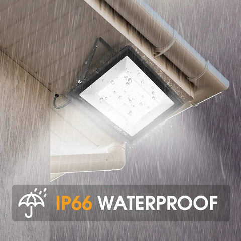 2 Pack 200W LED Flood Light With 22500 Lumens, IP66 Waterproof Outdoor Floodlights mounted under eaves in rain, showcasing IP66 rating