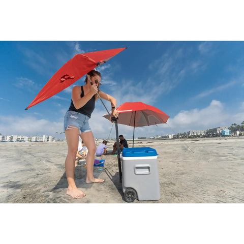 Woman adjusting Versa Brella Firebrick Clamp On Shade Umbrella With UPF 50 Plus Protection on a beach cooler for sun protection.
