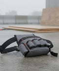Rig Ready Waterproof Oxford Canvas Tool Belt Waist Pack With Slick Adjustable Strap And Killer Storage Loops Hella Comfortable For Electricians Crushing It On Site, shown in rain on pavement.