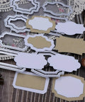 Lapoo metal cutting dies set for scrapbooking; assorted white and kraft label-frame shapes for DIY albums and cards.