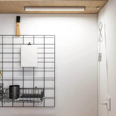 Under Cabinet LED Light Strip 12 Inch Plug In Slim USB Bar 6000K Cool White for Kitchen Cupboard Workbench Shelf Desk Bright Undercounter Lighting No Fuss Easy Install No Tools Needed installed under a wooden cabinet with visible wire and shelf.