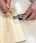 Using Straight Shooter Nine In One Measuring And Marking Tool Featuring Dual Levels Sliding Bevel to mark wood.