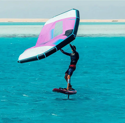 Person using the Inflatable Wing Surfboard Kite For Foil Wing Surfing And Handheld Kitesurfing With Hydrofoil Ready Design