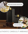 Hexagon Flameless Moving Flame Pillar Candles Set Of 2 In Chalky Black Finish Unscented Real Wax on a wooden table with pinecones