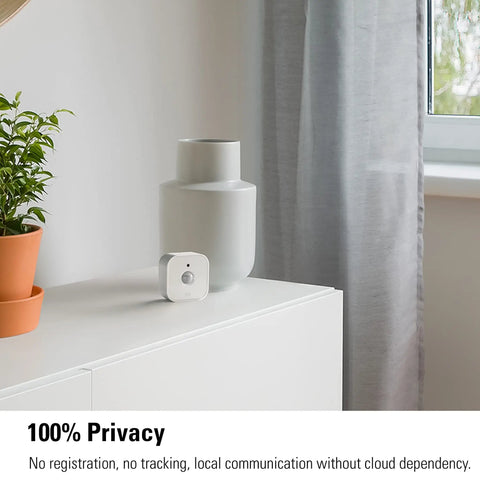 Super Smooth Wireless Smart Motion Sensor 3 Pack Wide Angle Indoor Outdoor Detection No Sweat Setup Works With Apple Home Alexa Google SmartThings Automate Your House Like A Pro Requires Thread Border Router on a shelf next to plant and vase.