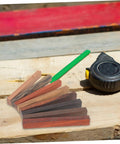 Top Shelf Wood Pen Blanks For Turning 8 Pack Exotic Lumber with varying colors on workbench with tape measure.