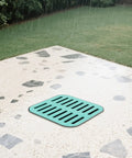 Heavy Duty Catch Basin With Grate And Debris Basket For Yard Drainage and Lawn Downspouts French Drain Systems No Reserved Hole Municipal Pipeline Pro Grade Durable Composite Resin Construction 15.7Inch Cube installed in patio