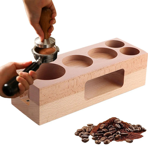 Person using Rock Solid Fifty Eight Mm Espresso Tamping Station made from sturdy natural wood for barista tools and coffee preparation.
