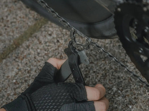 Close-up of cyclist using Five In One Bike Tool With Chain Tool And Master Link Pliers, Ultra Compact Durable Cycling Repair Kit.