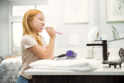 Child brushing teeth at sink with High Arc Matte Black Lavatory Faucet With 1 Or 3 Hole Install, Water Sense ADA Compliant
