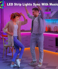 Couple enjoying 100Ft RGB LED Strip Lights Kit With 2 Rolls Of 50Ft in a kitchen with color changing ambiance for parties