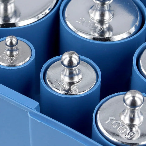 Close-up of Two 1000G Calibration Weights Set For Digital Scales With Tweezers, stainless steel weights in storage box