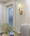 Set of 2 Rustic Industrial Wall Sconces With Flared White Textile Shades and Antique Brass Tapered Column Stands, Hardwired E26 Base, Vintage Modern Lighting for Living Room, Hallway, Bedroom displayed in an elegant room.