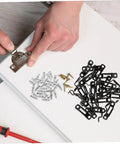 Hands attaching a metal hinge on a wood panel, surrounded by screws and black furniture connector slide buckles.