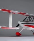 Side view of Ultimate 3D 950mm RC Airplane With AS3X Safe Technology featuring red and white biplane design.