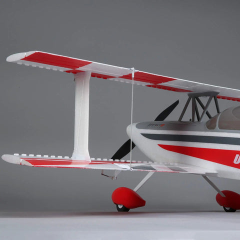 Side view of Ultimate 3D 950mm RC Airplane With AS3X Safe Technology featuring red and white biplane design.