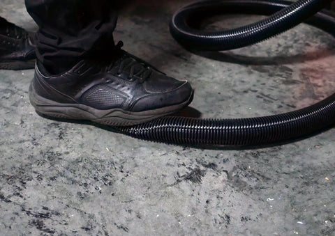 Person stepping on 50 Foot Ultra Flexible Crushproof Commercial Vacuum Hose 1.5 Inch Inner Diameter For Backpack and Canister Vacs