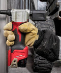 Killer Grade Cordless Rivet Tool Fits Milwaukee M12 12V Systems used to fasten metal sheets with gloved hand.