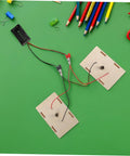 Hands On Stem Circuit Experiment Kit For Interactive Science Projects With Series And Parallel Circuits on green background.