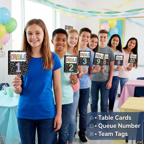 Students holding Classroom Table Numbers 1 Through 10 With Stands Group Cards For Easy Teacher Management Back To School Decor Team Labels And Signs For Classrooms Today in a decorated classroom.