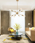 Gold Sputnik Chandelier 8 Light Modern Ceiling Fixture illuminating a contemporary living room with mid-century furniture.