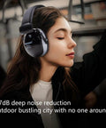 Woman wearing 37dB Gun Range Ear Protection Muffs with Adjustable Headband in an outdoor setting.