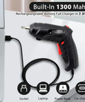 Easy Grip Cordless Electric Screwdriver With Bright Led Work Light And Rapid Usb Charging Solid Rechargeable Power Drill Kit With 47 Bits charging next to a laptop via USB cable.