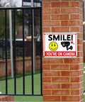 Legit Heavy Duty Aluminum Security Camera Signs Straight Up Warning To Scare Off Thieves Keep Your Home Yard Or Business Locked Down Bright Orange Black Cctv 4 Pack on brick fence.