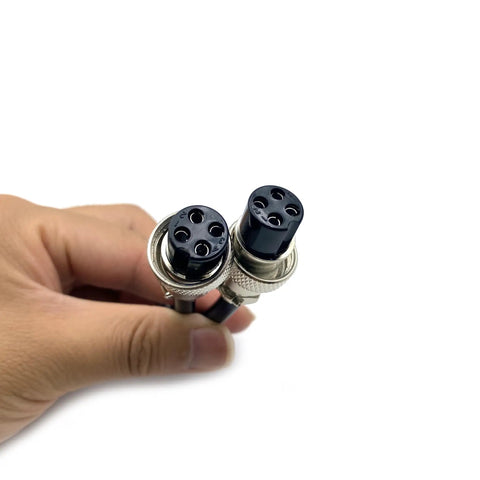 Close-up of GX16 4 Pin Double Female Aviation Cordset for Marine Use, showing metal connectors in hand, 1 meter length.