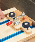 Using Eight Pack T Track Knob Kit with four star knobs and skeleton knobs on woodworking jig for precise cuts