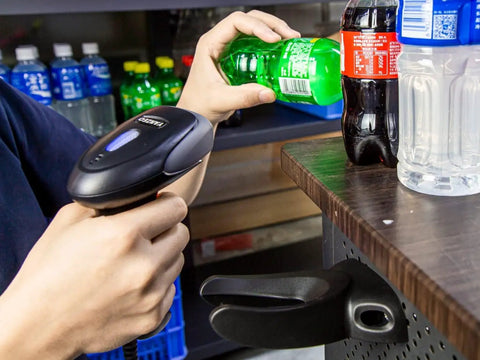 Person using Handheld USB Barcode Scanner, Wired CCD Barcode Reader on bottle, showing easy setup and fast scanning in store setting.
