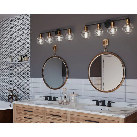Coastal Four Light Bath Vanity Light With Clear Glass Globes In Antique Bronze Finish above bathroom mirror